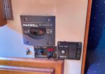 Maxwell circuit breaker isolator panel with bilge pump controls on a boat wall near a wooden trim.