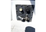 Close-up of a Navtec control panel on a boat deck, featuring a circular gauge, two knobs, and a lever on a dark rectangular plate.