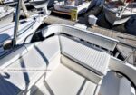 White flybridge seating on a boat in a marina; upholstery looks in very good condition (caption reads 'Flybridge Upholstery in very good condition...').