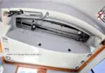 Hidden rod storage above the salon with fishing rods secured in a recessed compartment by the ceiling panel.