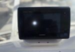 Garmin GPS navigation display mounted on a boat helm with a dark screen.