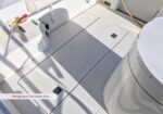 Boat deck with refrigerated fish boxes, hatches, and exposed plumbing; partial label reads 'Refrigerated Fish Boxes Port...'