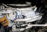 Close-up of a CAT 3126 diesel engine with hoses, pipes, and a CAT filter visible in the engine bay.
