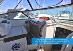 Luxurious boat cockpit with light-gray seating; windshield view of marina. Caption notes the portside companion seat keeps guests close to the action beside the captain.