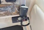Midland two-way radio microphone with a coiled cord mounted inside a vehicle cabin.