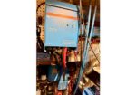 Blue MultiPlus inverter/charger unit mounted in an electrical equipment rack with various cables and components surrounding it