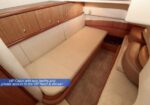 VIP yacht cabin with twin berths, beige seating, and wooden cabinets; private access to the VIP head and shower.