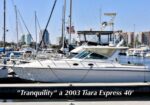 White Tiara Express 40 motor yacht named 'Tranquility' docked at a marina with a city skyline in the background.