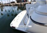 White motorboat with an extended swimstep at the stern; the label 'Extended Swimstep' is visible on the platform.