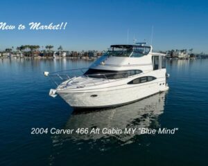 White motor yacht on calm blue water with overlaid text 'New to Market!!' and listing name '2004 Carver 466 Aft Cabin MY "Blue Mind"' indicating a boat for sale.