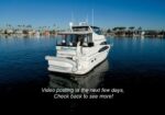 White motor yacht named Blue Mind on calm harbor water with a marina in the background; caption reads, 'Video posting in the next few days. Check back to see more!'