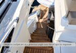 Wooden yacht ladder descending to the cockpit with side handrails, angled for easy access.
