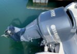 Yamaha 350 outboard motor mounted on the stern of a boat in calm green water