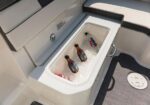Built-in boat cooler filled with ice and multiple bottles and drinks chilling inside.