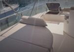 White cushioned sunpad on a boat deck with marina and water in the background