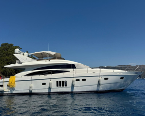 2007-princess-21m-power-10044837-20251223123853267-1 | Boat Universe White luxury motor yacht anchored in calm blue water, with yellow mooring lines and distant coastline under a clear sky.