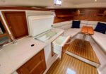 Boat galley with open freezer and pull-out drawer, wood cabinets, and beige countertop. (Note: concise informative alt text.)