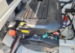 Volvo Penta D3-220 diesel engine in a boat engine compartment with red oil cap and yellow coolant label nearby