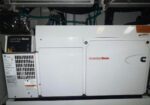 Cummins Onan generator in a mechanical room, white two-panel unit with control box on the left.