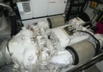Large white generator engine with dual air filters in a mechanical room