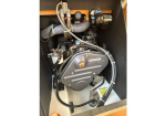 Yanmar marine diesel engine installed in a boat's engine compartment, with hoses, wiring, and a flex exhaust hose.