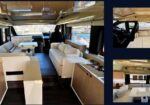 Luxurious motor yacht interior: white sofas, a central dining table, and a kitchenette with wood cabinets, windows showing the harbor ahead.