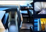 View from the cockpit of a luxury boat: helm with gauges and control panel, wood stairs descend to the lower deck.