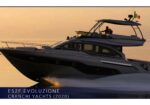 Cranchi E52F Evoluzione motor yacht at sunset with two people on the upper deck and the Italian flag