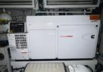 Cummins Onan standby generator in a mechanical room, with control panel on the left and ventilation panels nearby.