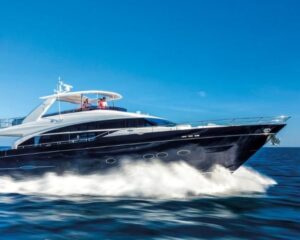 4863151_20141103033945421_1_XLARGE | Boat Universe Black luxury motor yacht speeds over blue water, leaving a white wake under a clear sky.