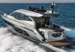 Luxurious motor yacht speeding across blue sea, leaving a frothy wake behind it