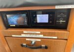 Boat electrical panel with two screens and an 'Electrical System' label below.
