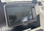 Boat cockpit touchscreen by Raymarine with a warning sticker reading 'THIS UNIT IS NOT CONNECTED TO THE FLYBRIDGE UNIT' above the display.