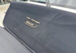 Boat seat cover on a Whaler boat, text reads '420 Outrage' with a Whaler logo in gold.