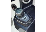 Boat throttle lever and control panel on a boat console, with gear indicators and a circular selector knob.