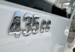 Chrome 435cc badge on a white surface, reflecting the surroundings.
