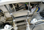 Metal ladder with rubber treads ascending inside a cluttered boat maintenance area, with hoses, containers, and electrical components around it.
