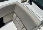 Beige leather boat seat and backrest on a white deck with nearby stainless hardware.