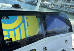 Boat cockpit with two Garmin displays; left shows navigation map with depth 26.9 ft and speed 6.81 mph, right shows sonar/chart data.