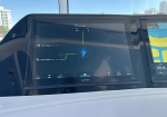 Garmin boat display showing a battery management diagram: two house chargers connected to a central blue lightning bolt icon, with a map/depth screen to the right.