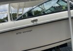 White motorboat with '270 Vantage' printed on the hull, resting on a trailer by the water, with registration FL652IPY visible on the windshield side window.